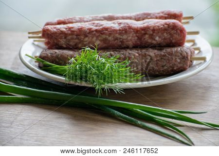 Raw Lulya Kebab From Meat On A White Plate.