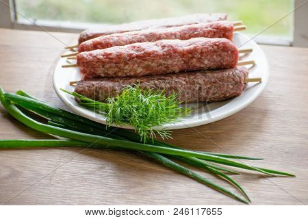 Raw Lulya Kebab From Meat On A White Plate.
