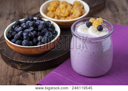 Smoothies Of Cloudberries, A Banana And A Blueberry On A Lilac Napkin And Blueberries And Cloudberri