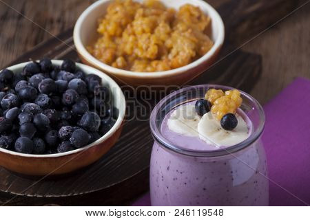 Smoothies Of Cloudberries, A Banana And A Blueberry On A Lilac Napkin And Blueberries And Cloudberri