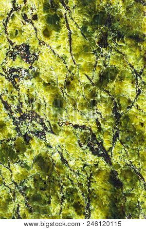 Vertical Background From Polished Greenish Serpentinite Natural Stone Close Up