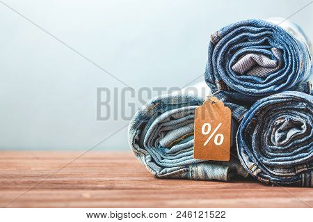 Concept Sales, Black Friday Discounts With Tag, Blue Jeans On A Light Background Copyspace