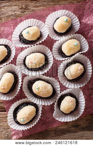 Brazilian Dessert Sweets Olho De Sogra From Condensed Milk, Prunes And Coconut Close-up. Vertical To
