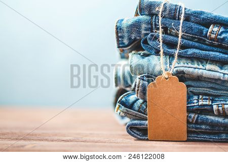 Sale, Discount, Black Friday Concept With Tag , Blue Jeans On A Light Background. Copyspace.