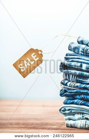 Concept Sales, Black Friday Discounts With Tag, Blue Jeans On A Light Background Close Up Sale Sings