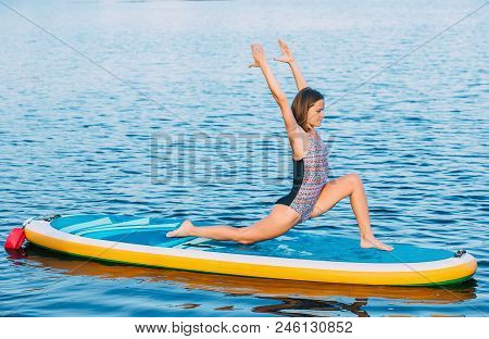 Pretty, Sporty Woman In Yoga Position On Paddleboard, Doing Yoga On Sup Board At Sea