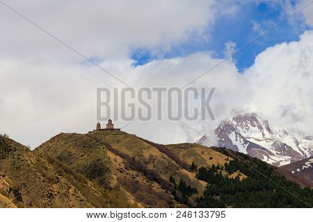 View On The Mount Kazbek And Gergeti Trinity Church (tsminda Sameba), Holy Trinity Church Near The V