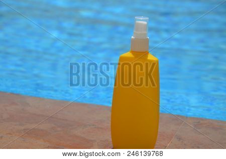 Summer-yellow Sunblock Cream In Blue Outdoor Swimming Pool