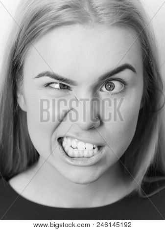 Girl Is Yelling At The Camera. Woman Squinting Eyes On Silly Face With Makeup Foundation. Funny Girl