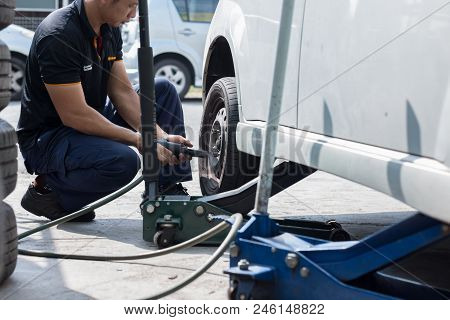 Selangor, Malaysia - June 28, 2018: A Mechanic Is Changing The Car Wheel At Tyre Shop In Kajang, Sel