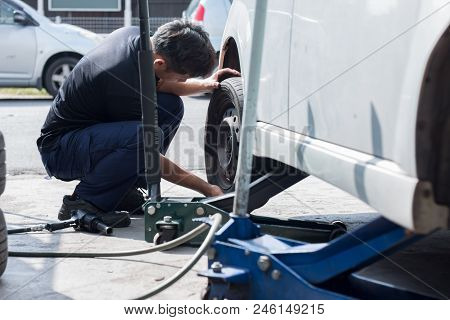 Mechanic Is Changing Car Wheel At Tyre Shop.