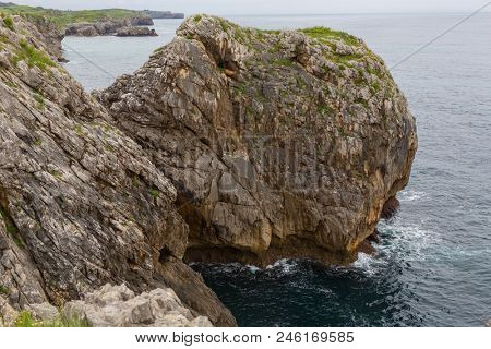 Coastal cliffs near of the beach Gulpiyuri, Asturias, Spain