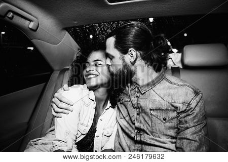 Romantic couple in the backseat of a taxi
