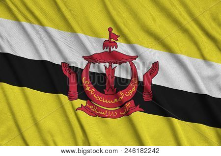 Brunei Darussalam Flag  Is Depicted On A Sports Cloth Fabric With Many Folds. Sport Team Waving Bann