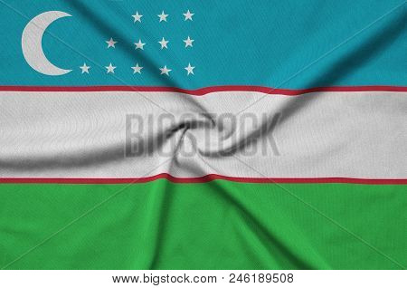 Uzbekistan Flag  Is Depicted On A Sports Cloth Fabric With Many Folds. Sport Team Waving Banner