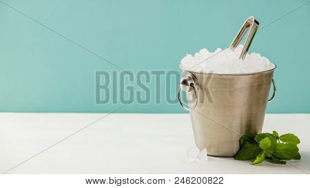 Metal ice bucket and mint
