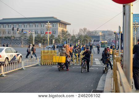 Beijing, China - March 12, 2016: Pedestrians And Cyclists Crossing The Bejing Street Intersection.