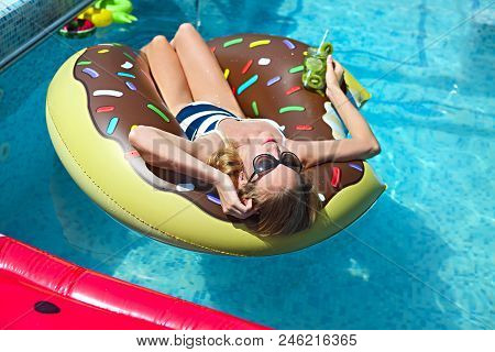 Young Woman On Summer Pool Party In Swimming Pool Drinkig Lemonade