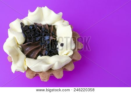 Cake Basket Of Short Pastry Cream And Chocolate Close-up On Purple Background