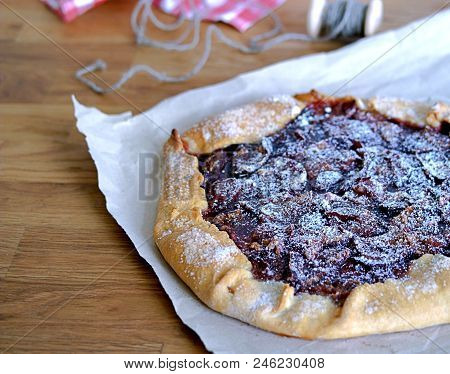 Open Pie-gallets From Fresh Dough With Plums And Cinnamon. Sprinkled With Powdered Sugar. Rustic Sty