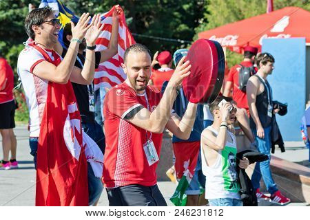 Football Fans Of The National Team Of Tunisia With National Flags And Attributes