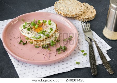 Breakfast Fried Egg, Micro Greens And Bread On A Pink Plate.