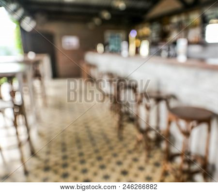 Blurred Background Of Bar In Loft Style. There Are High Chairs Closed To Bar