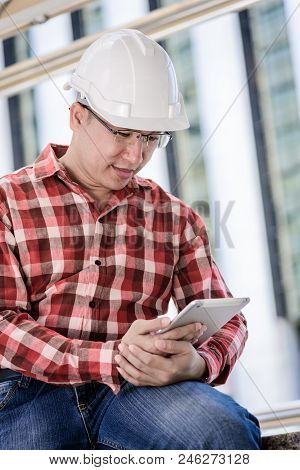 Asian Business And Engineer Man With Red Scott Shirt Has Planning And Working For Design Buiding And