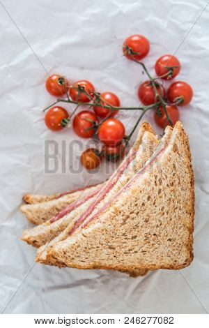 Wholemeal bread sandwich topped with Lyon rosette and butter