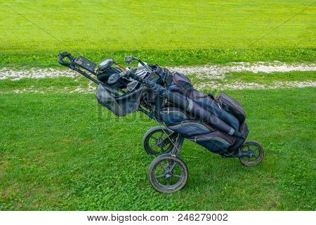 Golf Bag With Clubs On Roller Stand On Golf Course, Authentic, Not Staged, After Plaz With Muddy Whe
