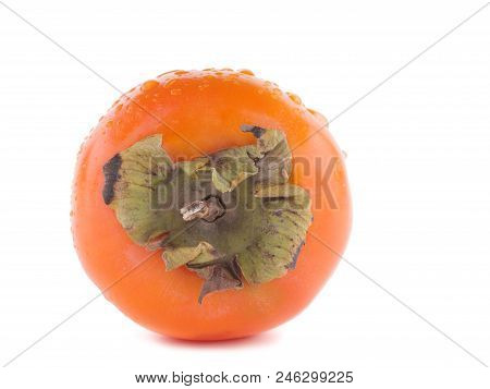 A Ripe Persimmont Of Orange Colour Is Lying On The White Background.