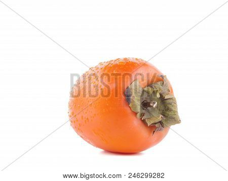 A Ripe Persimmont With A Tale Is Lying On The White Background.
