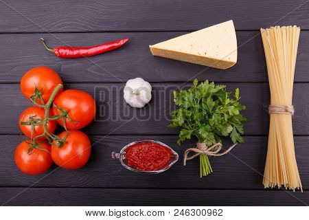 Tasty And Appetizing Tomatoes Parsley Chese Ketchup Garlic Hot Chili Peppers And Dry Pasta Are Lying