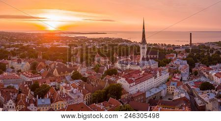 Beautiful Orange Sunset Over Old Town Of Tallinn In Estonia With The Raekoja Plats, Castle And Old M