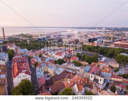 Beautiful Orange Sunset Over Old Town Of Tallinn In Estonia With The Raekoja Plats, Castle And Old M