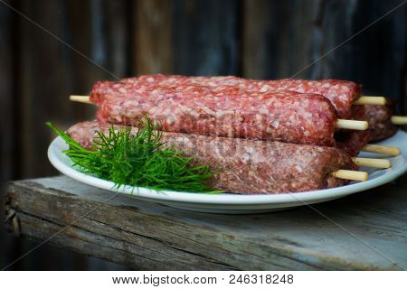 Raw Lulya Kebab From Meat On A White Plate.