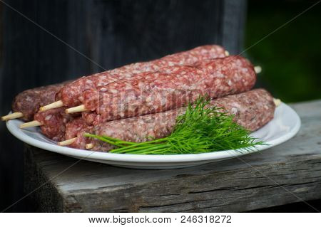 Raw Lulya Kebab From Meat On A White Plate.