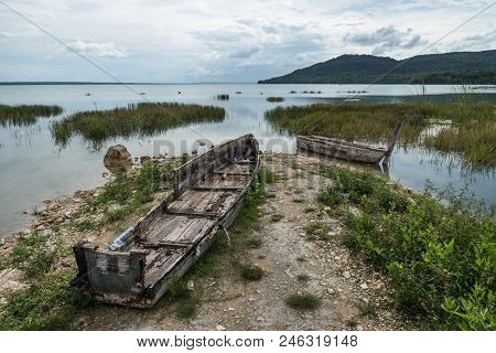 Abandoned Boats On The Beach With Cloudscape At El Remate, Peten, Guatemala