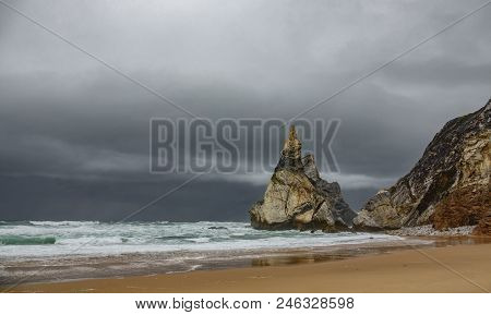 Praia Da Ursa Beach Under Stormy Clouds
