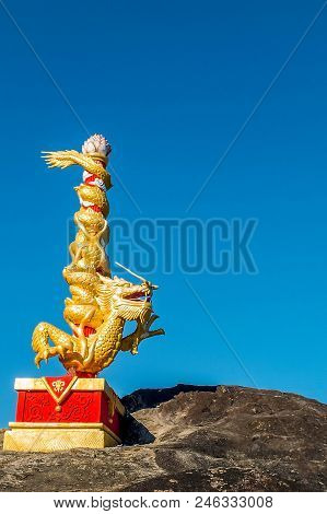 The Elegance Of The Chinese Dragon Statue Over The Stone.