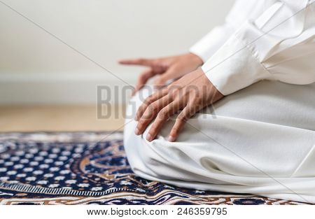 Muslim praying in Tashahhud posture