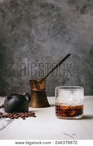 Iced Coffee Cocktail Or Frappe With Ice Cubes In Glass With Vintage Jezva, Milk Jug And Coffee Beans