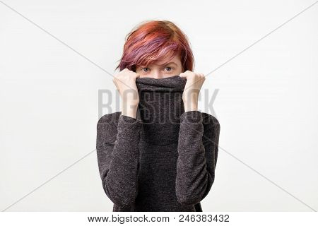 Anonymous Concept. Young Woman With Interesting Colorful Hairstyle Hiding Her Face With Colar. She D