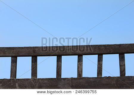A Ladder Of Old Wood Laid Against A Background Of Blue Sky