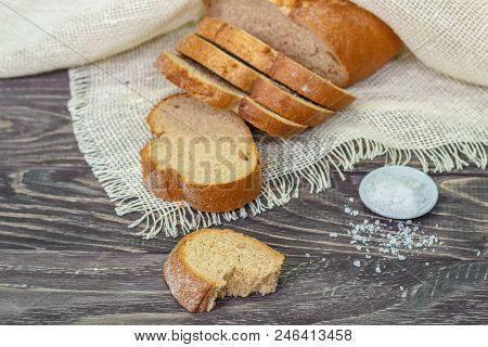 Still Life With Slices Of Bread On A Wooden Background