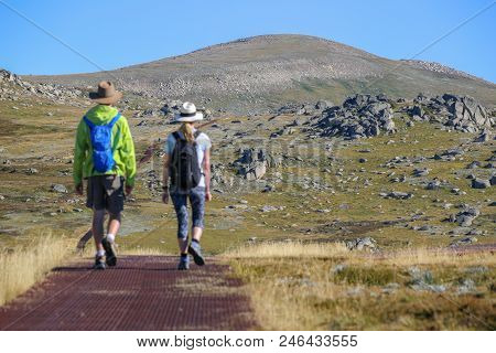 Walk Trail On Mountain Kosciuszko. Two People, Adventure Lovers, A Man And A Girl. Kosciuszko Nation