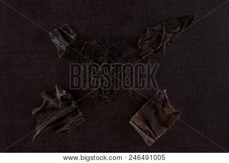 Traditional Chinese Medicine Seaweed And Dan Shen On Black Background. Tcm Top View.