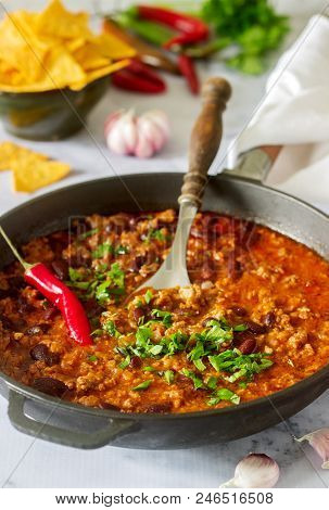 Mexican And American Food Chili Con Carne Served With Nachos, Pepper And Herbs. Selective Focus.