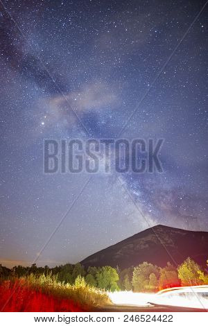 A View Of The Stars Of The Milky Way With A Mountain Top In The Foreground. Night Sky Nature Summer 