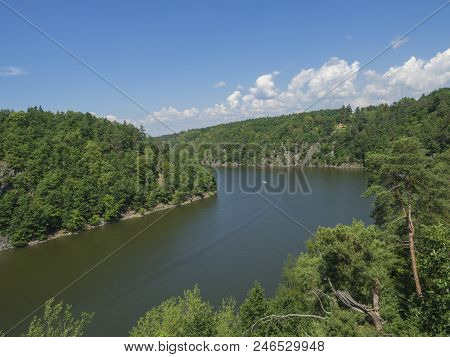 View From Bridge Zvikov On Otava And Vltava River With Green Tree Forest Rocky Shore Blue Water, Boa